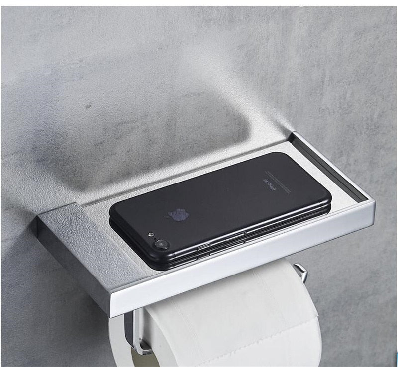 silver toilet paper holder with storage shelf and bathroom accessories