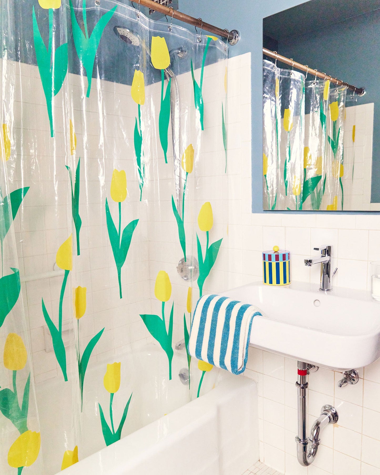 Dusen Dusen Tulip Shower Curtain. Yellow tulip petals with green stems printed on clear background. Embossed logo in bottom corner. 100% PEVA free of PVC and BPA. 12 anti-rust stainless steel grommets.; A floral shower curtain that WON'T activate your seasonal allergies.